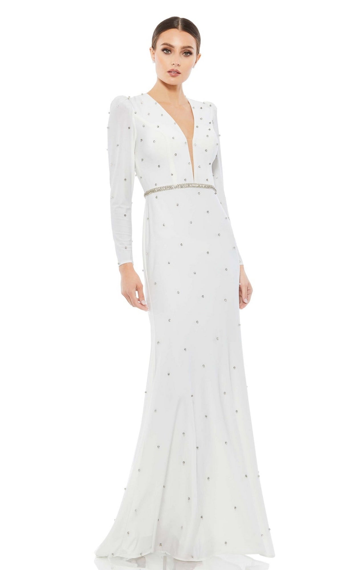 A woman wears the Long Formal Dress 67874 by Mac Duggal, featuring long sleeves, a plunging v-neckline, silver embellishments, a fitted waist, and a formal floor-length silhouette.